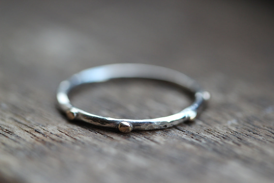 Scattered gold stones on silver ring